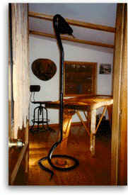 Private treatment room with hand crafted cedar table and kundalini stand for Ayurvedic massage; abhyanga, pizhichil, and shirodhara using oils from the Ayurvedic clinics of Kerala, India.